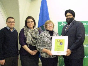 Accepting the award from Service Alberta Minister  Manmeet S. Bhullar, are Dr. Diane Rhyason, (CPLEA executive director), Rochelle Johannson (CPLEA Lawyer) and Ryan Day (Youth Program Coordinator)